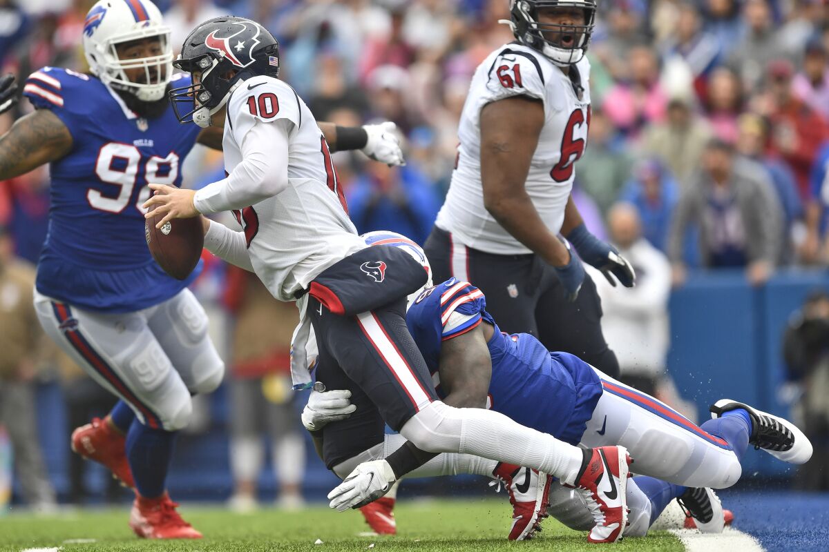 Houston Texans quarterback Davis Mills (10) is sacked by Buffalo Bills defensive end Boogie Basham (96) during the first half of an NFL football game, Sunday, Oct. 3, 2021, in Orchard Park, N.Y. (AP Photo/Adrian Kraus)