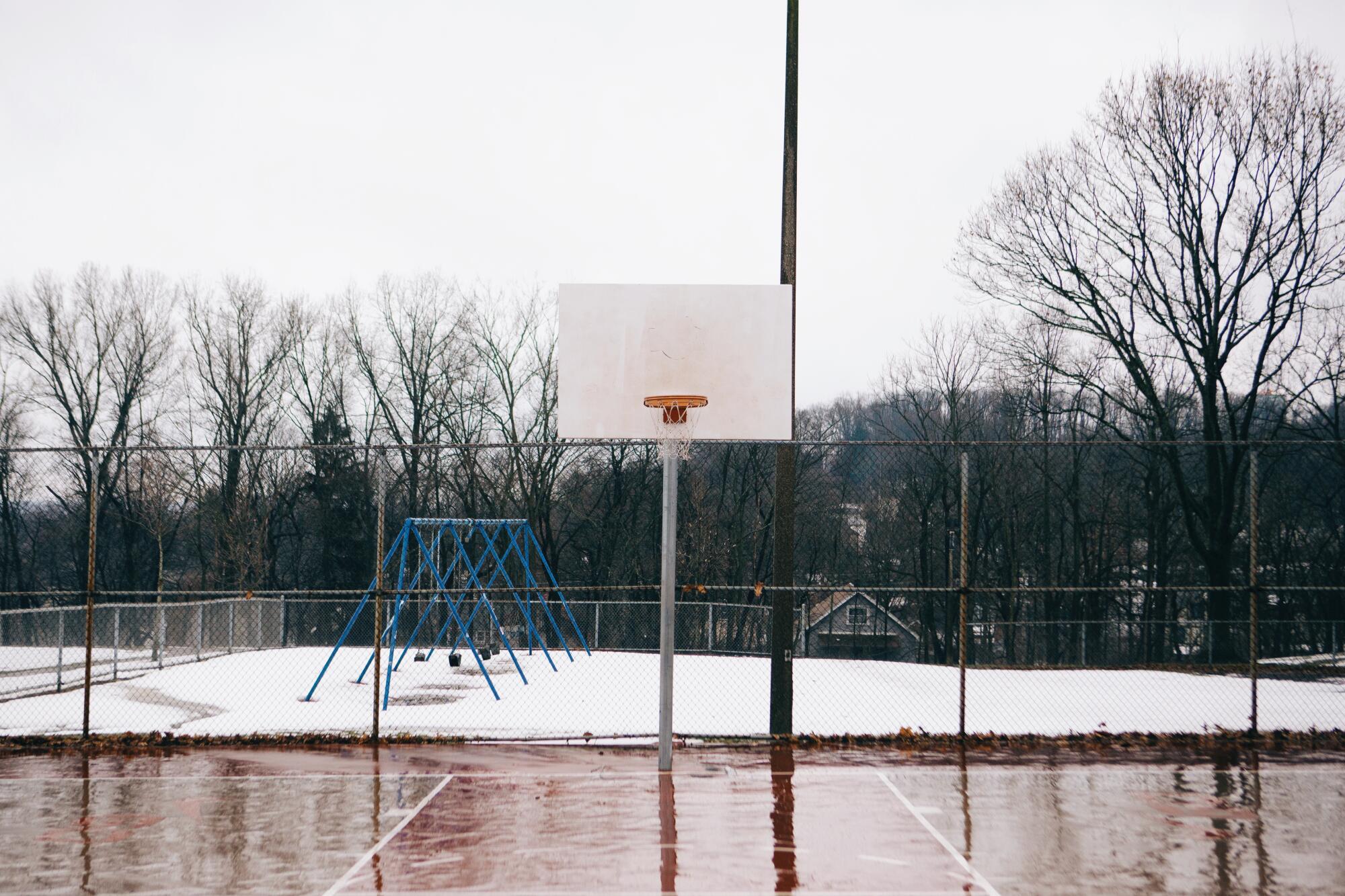 An empty Perkins Park basketball court in Akron on a wintry day.