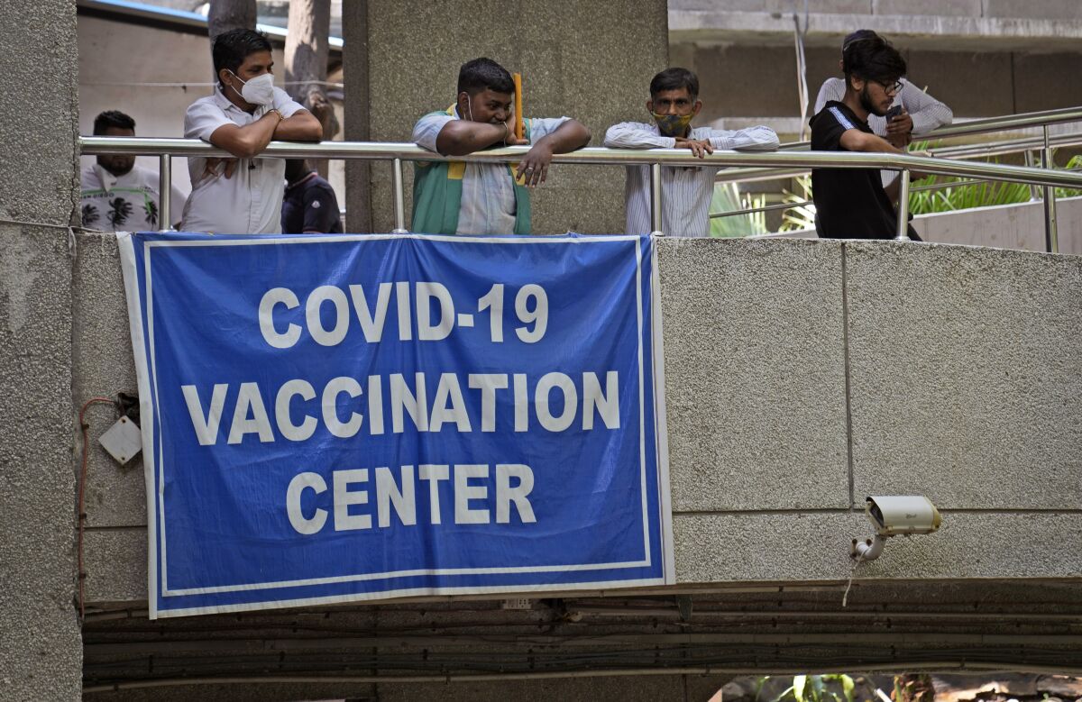 A sign on a balcony in New Delhi reads "COVID-19 vaccination center."