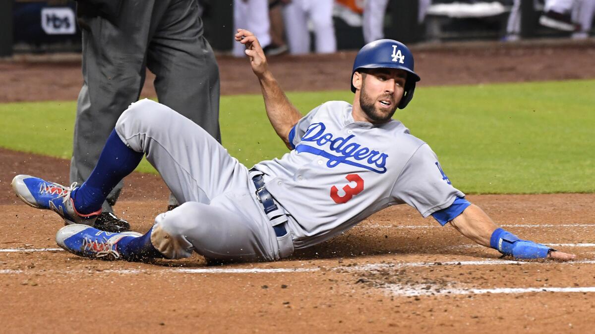 Chris Taylor slides into home for the first run of the game.