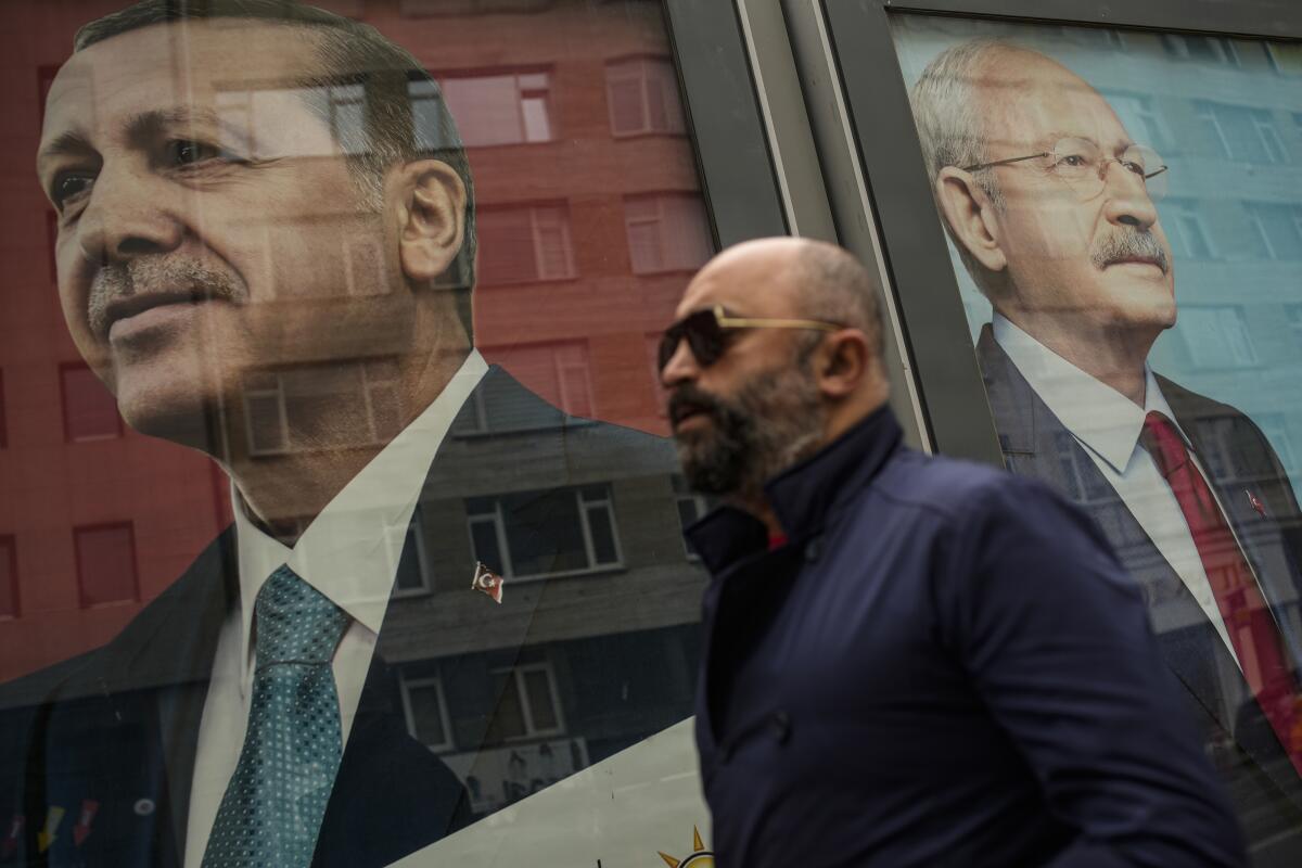 Man walking past campaign billboards in Istanbul