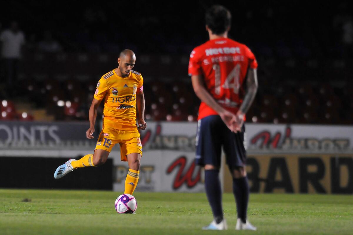 Sebastian Rodriguez (R) of Veracruz watches Guido Rodriguez Tigres, kicking the ball during the Mexican Apertura 2019 tournament football match at Luis Pirata Fuente stadium in Veracruz, Veracruz state, Mexico on October 18, 2019. - Veracruz players did not engage on the game for the first five minutes of the match to protest not receiving their salaries and received two goals. (Photo by VICTOR CRUZ / AFP) (Photo by VICTOR CRUZ/AFP via Getty Images) ** OUTS - ELSENT, FPG, CM - OUTS * NM, PH, VA if sourced by CT, LA or MoD **