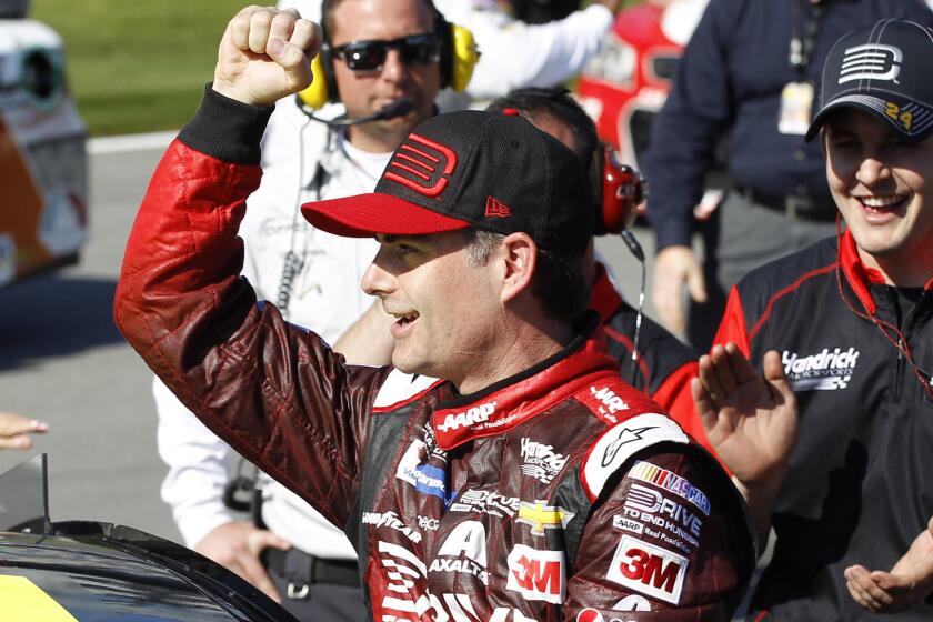 Jeff Gordon celebrates after winning pole position Sunday for next weekend's Daytona 500.