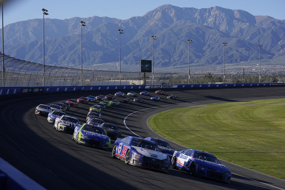 Joey Logano and Kyle Larson lead the field during a NASCAR Cup Series auto race at Auto Club Speedway