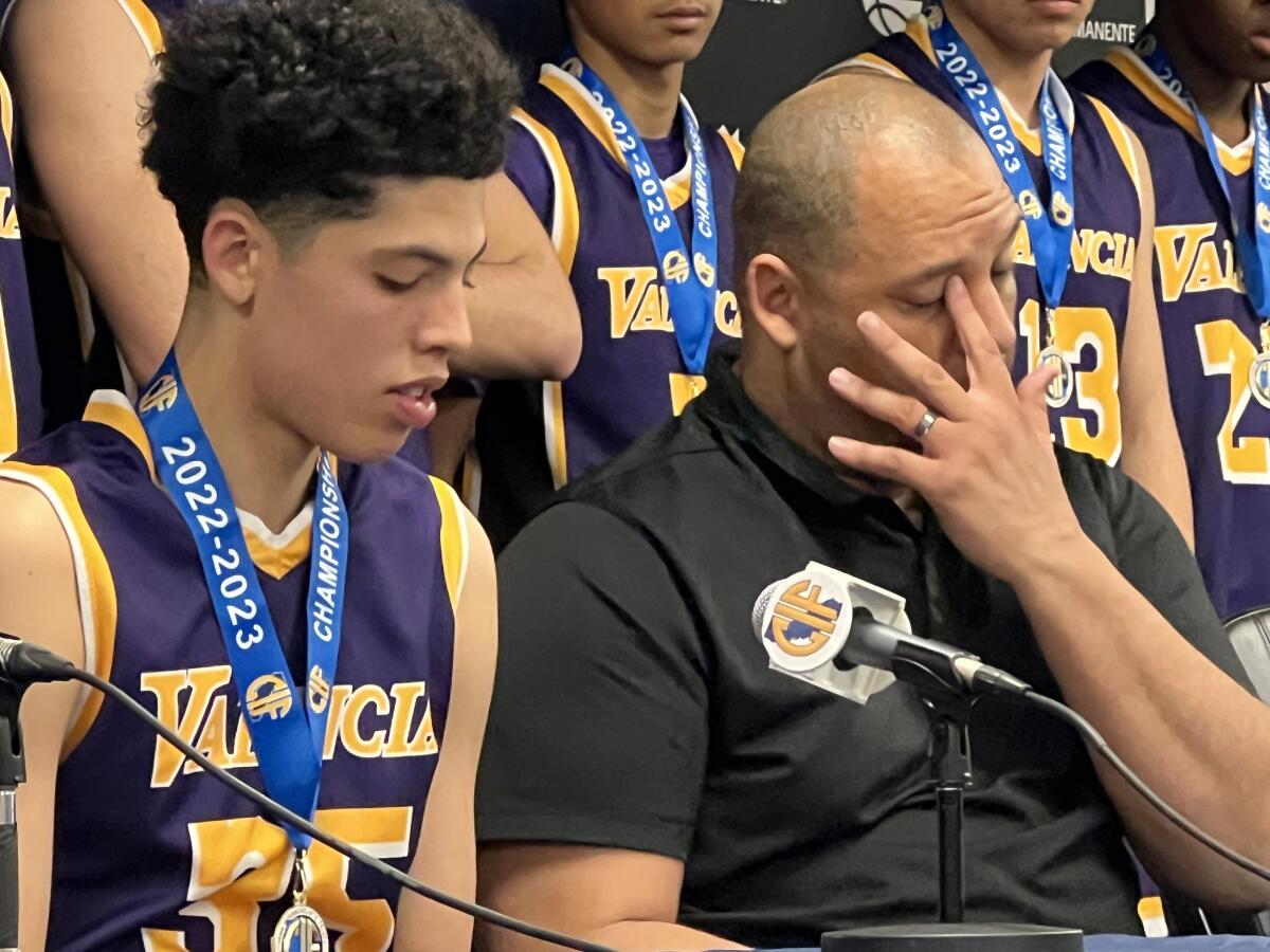 Valencia High boys' basketball coach Bill Bedgood wipes away a tear.