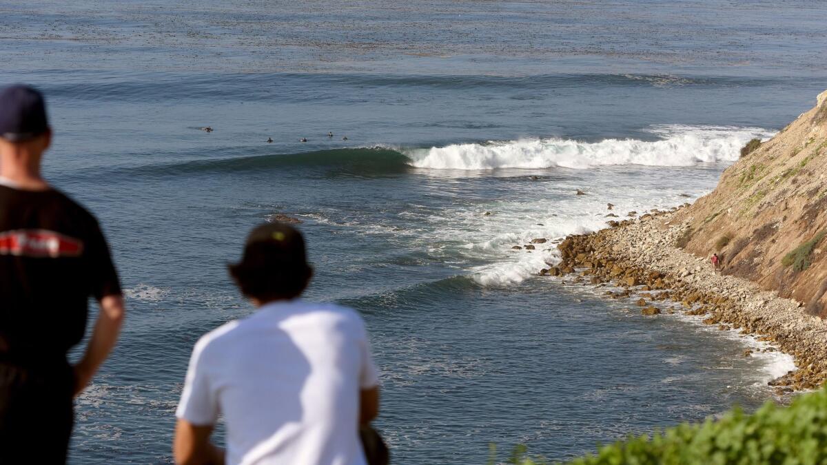 Cory Spencer, left, and Christopher Taloa watch the waves at Lunada Bay during a Martin Luther King Jr. Day event to protest the localism that has plagued the surf spot on the Palos Verdes Peninsula.