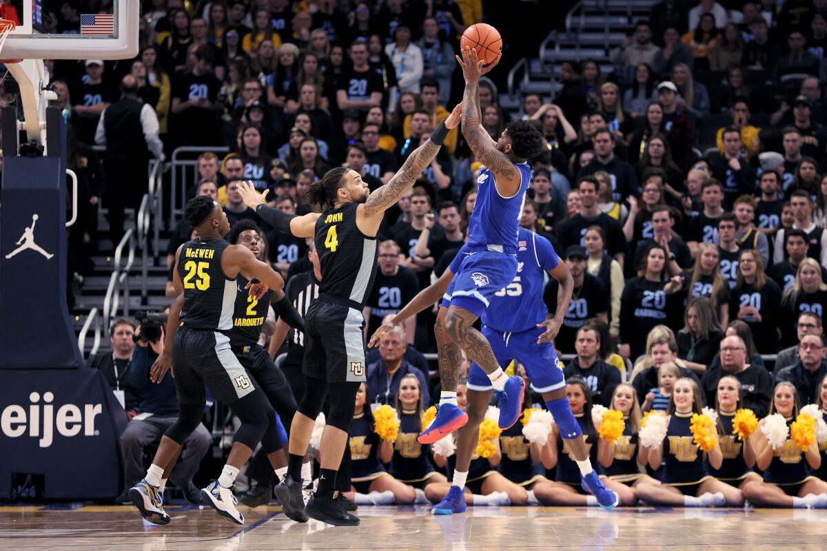 Seton Hall's Myles Powell attempts a shot while being guarded by Marquette's Theo John on Feb. 29 in Milwaukee.