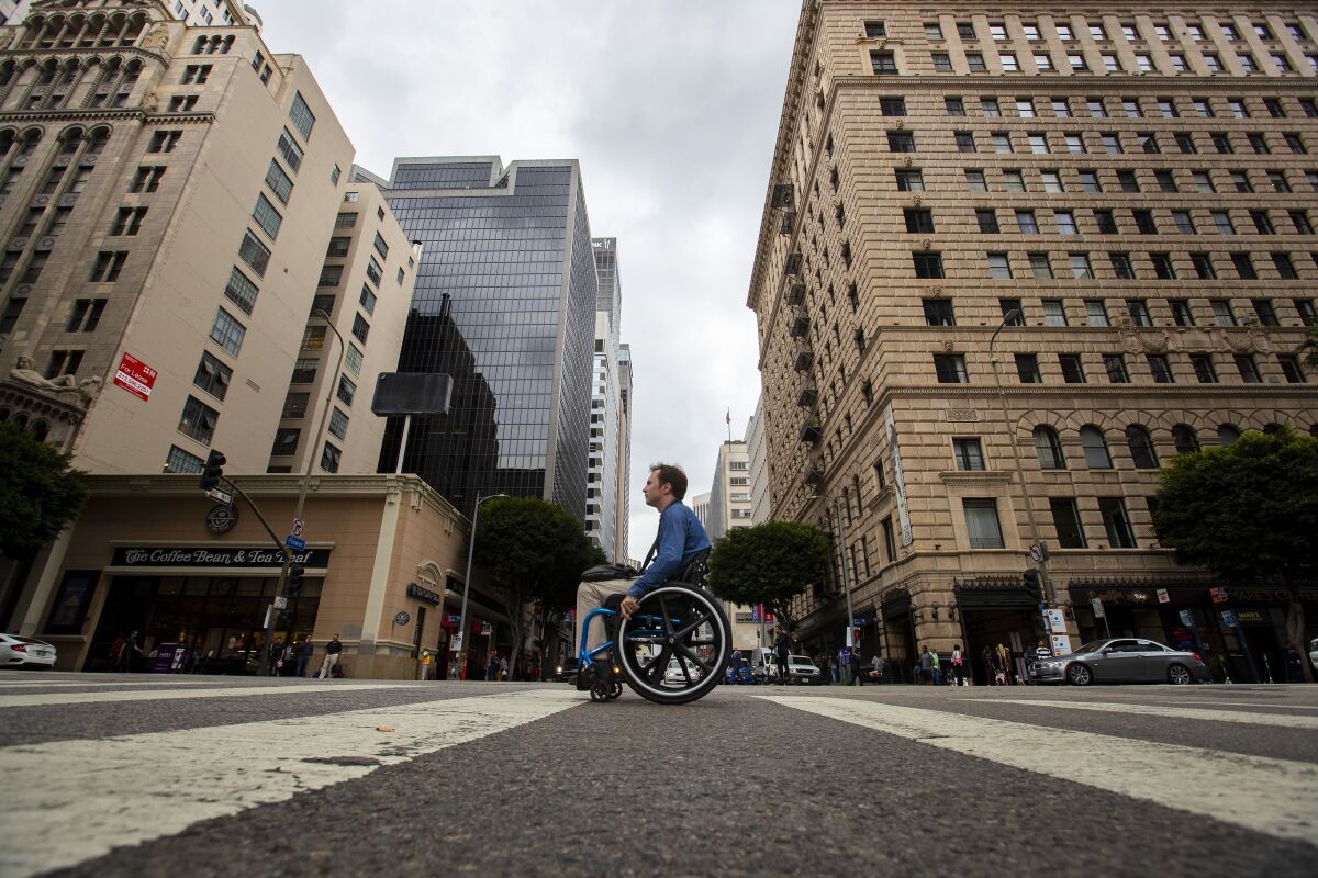 David Radcliff crosses Flower Street at 7th Street.