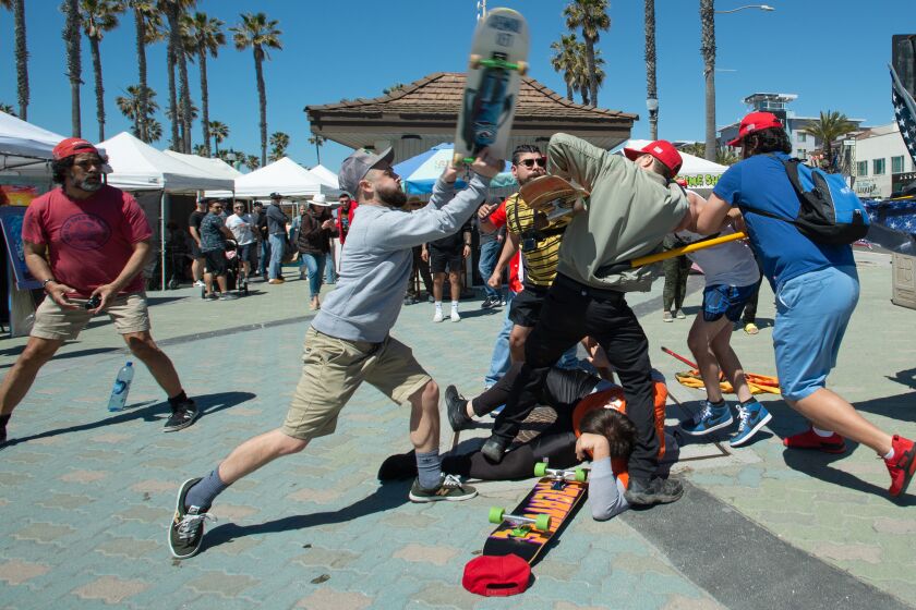 Skateboarders clash with demonstrators gathered in support of Trump at Huntington Beach Pier on Saturday, April 1. 