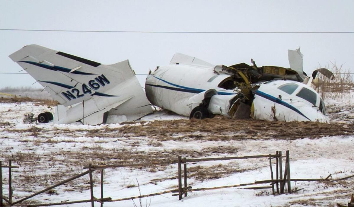 The wreckage of an airplane lies in a field in Havre-aux-Maison, Quebec. Among those killed was former federal Cabinet minister and political commentator Jean Lapierre.