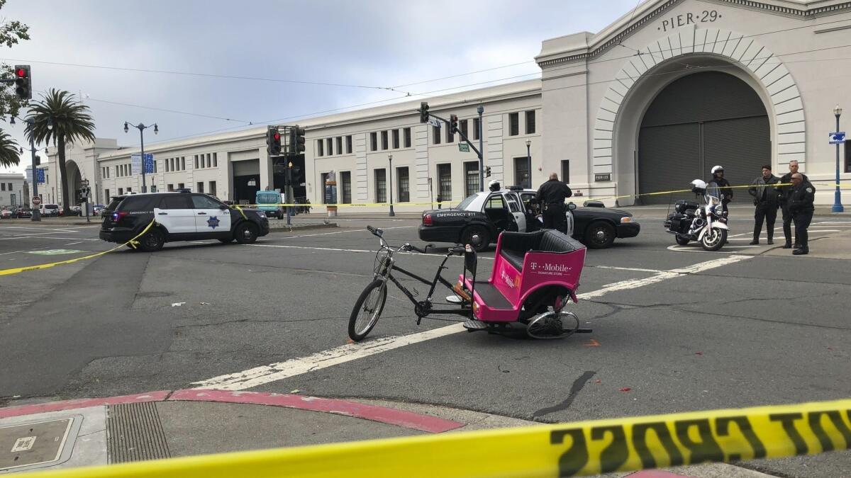 A crashed pedicab sits in the street in San Francisco on Wednesday after authorities said a hit-and-run driver crashed into it, injuring several people.