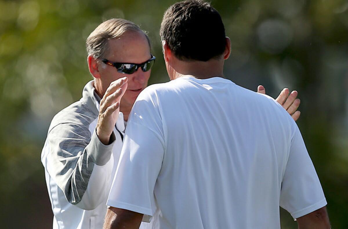 USC Athletic Director Pat Haden, left, talks to interim football Coach Ed Orgeron during a practice last week.