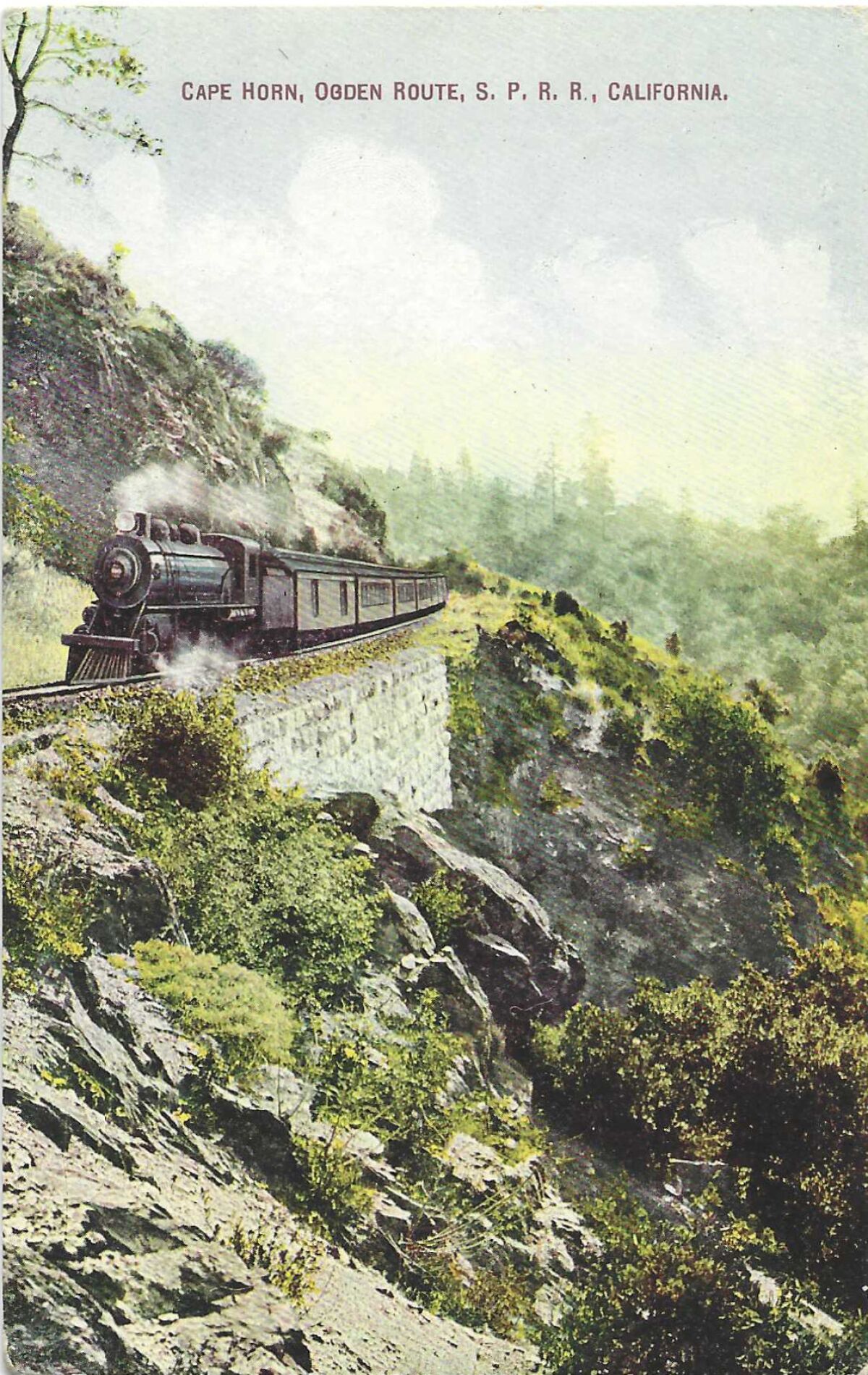 A locomotive on a mountain pass is depicted on a vintage postcard