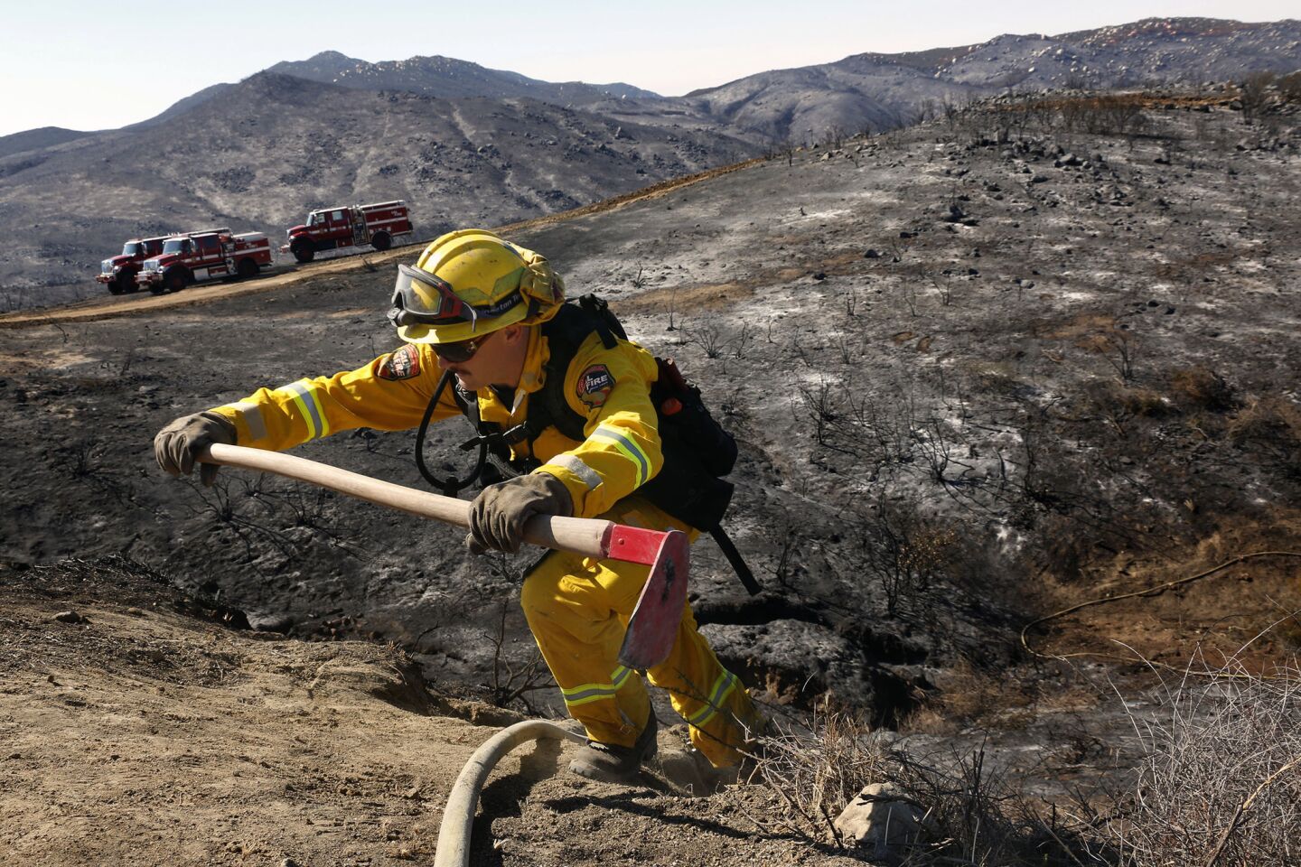 Lance Thibault climbs up a steep ridge to reach South Main Divide in Cleveland National Forest as firefighters continue to battle the 1,500-acre Falls fire near Lake Elsinore.