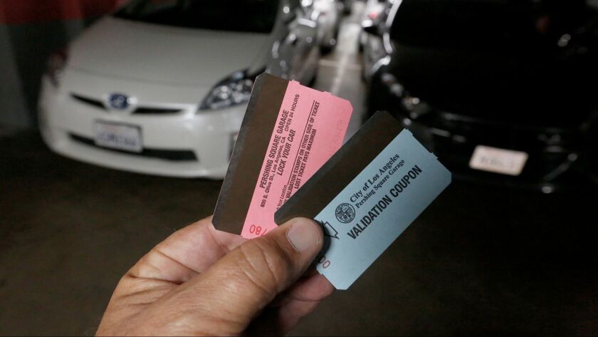 A driver displays tickets for the Pershing Square underground parking garage on April 22, 2016.