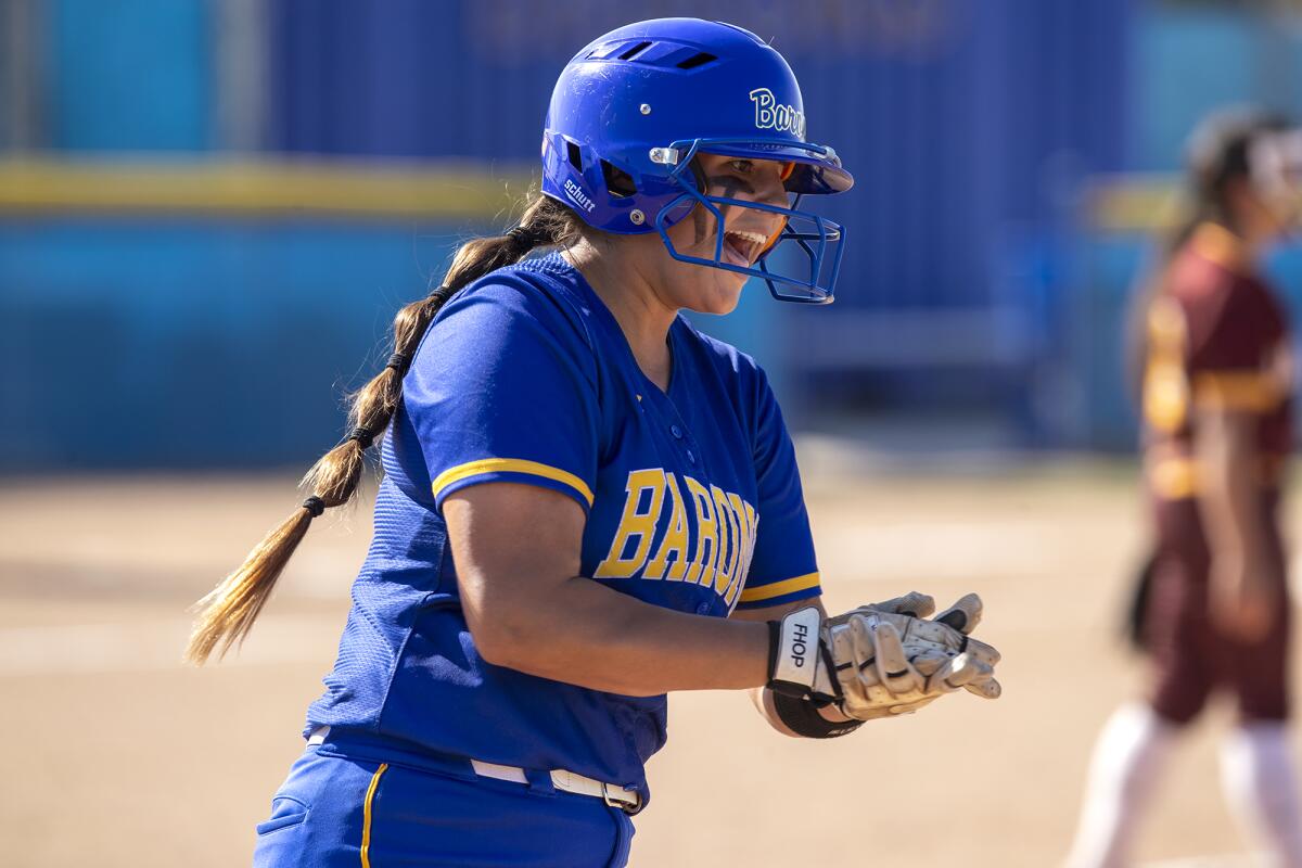 Fountain Valley's Makenzie Butt celebrates while rounding first after hitting a solo home run against Barstow.  