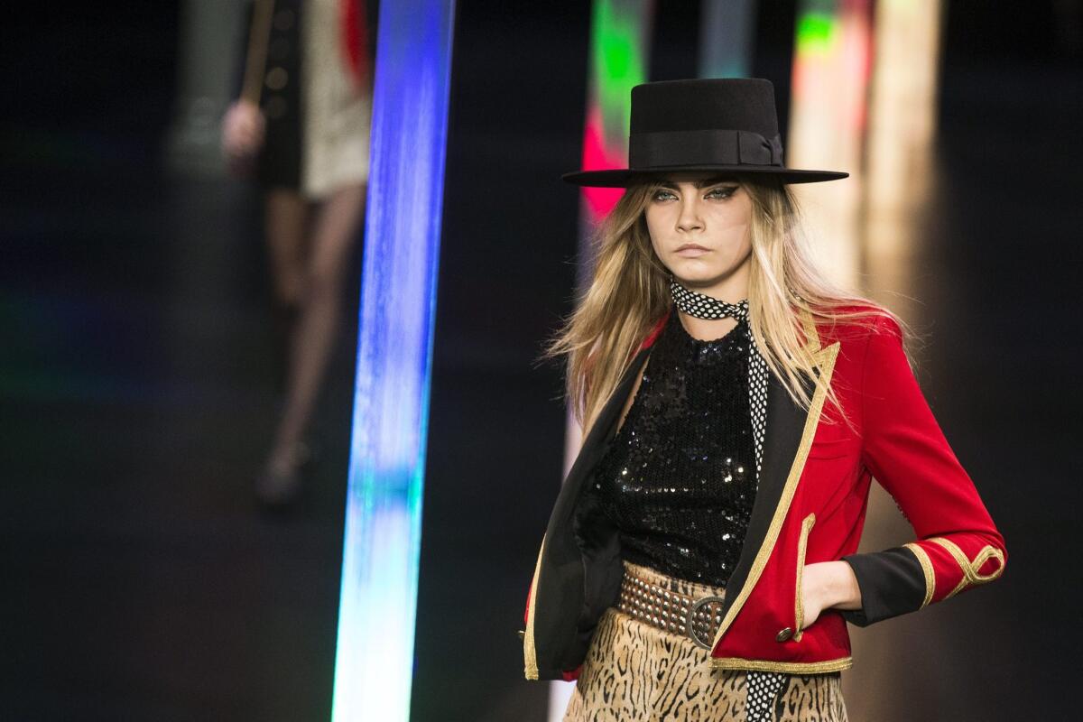 Cara Delevingne presents a look from the spring/summer 2015 collection from Saint Laurent.
