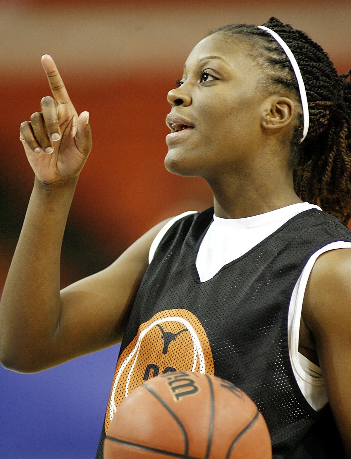 FILE - Texas forward Tiffany Jackson (33) points during Big 12 women's basketball tournament practice Monday, March 5, 2007 in Oklahoma City, Okla. Jackson, a former standout at the University of Texas who was the No. 5 pick in the WNBA draft in 2007 and played nine years in the league, has died of cancer, the school announced. She was 37. Jackson, who was first diagnosed with breast cancer in 2015, died Monday, Oct. 3, 2022. (AP Photo/Ty Russell)