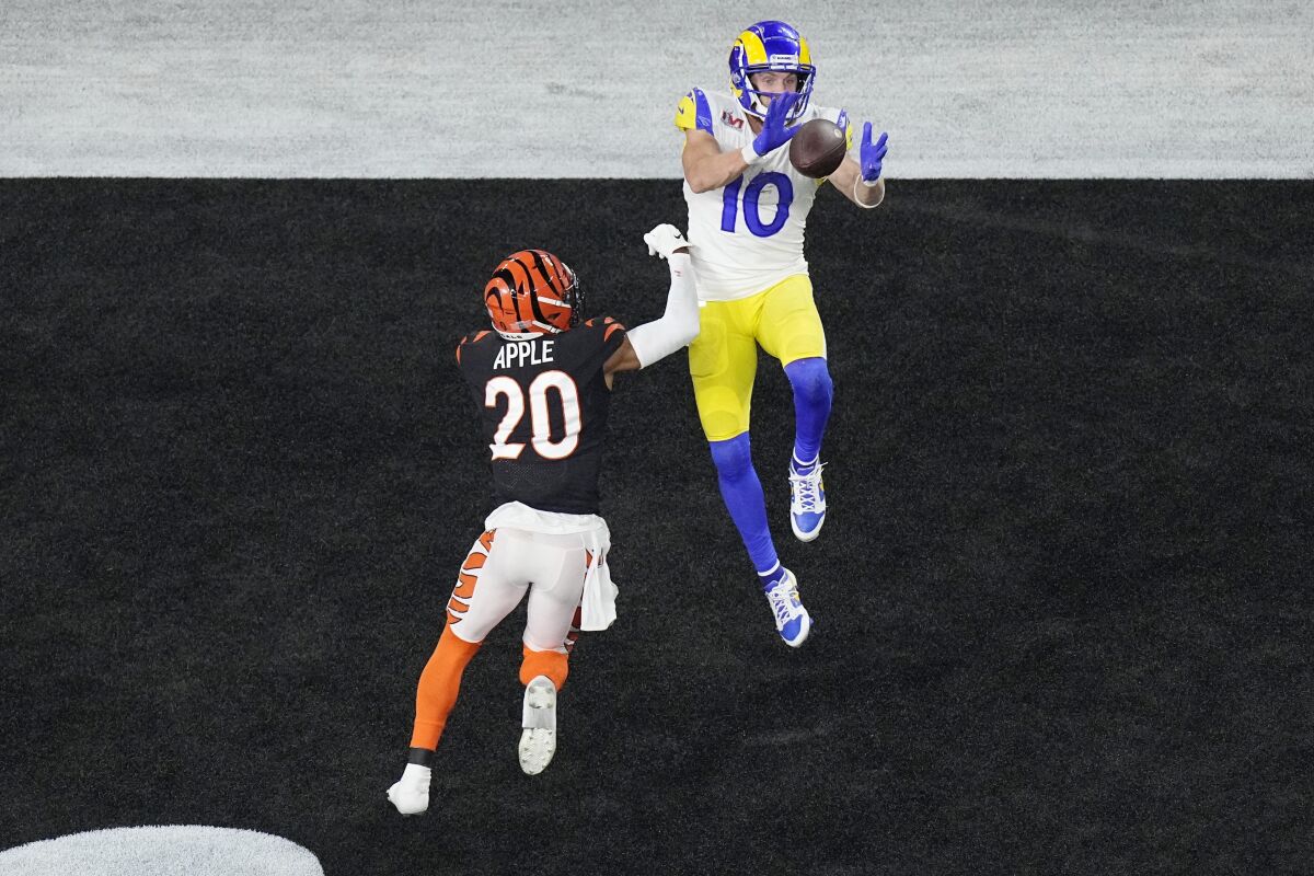 Los Angeles Rams wide receiver Cooper Kupp (10) grabs a touchdown pass as Cincinnati Bengals cornerback Eli Apple (20) is late with tackle during the second half of the NFL Super Bowl 56 football game, Sunday, Feb. 13, 2022, in Inglewood, Calif. (AP Photo/Matt Rourke)