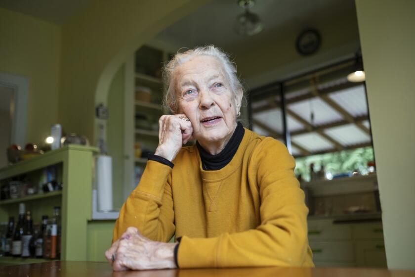 Karin Engstrom, 82, poses for photos at home, Wednesday, Sept. 27, 2023, in Seattle. Engstrom recently had student loans forgiven. She's one of 804,000 borrowers who will have a total of $39 billion forgiven under a one-time adjustment granted by the Biden administration. (AP Photo/Stephen Brashear)
