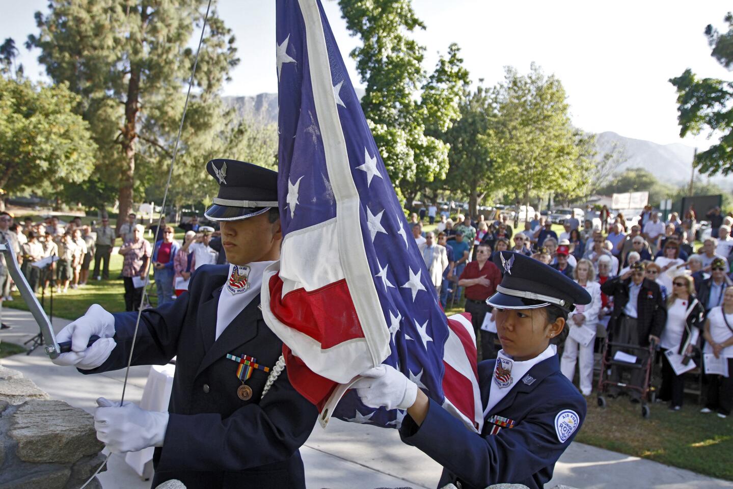 Members of the Crescenta Valley High School ROTC raise the US flag during Memorial Day celebration at Two Strike Park in La Crescenta on Monday May 26, 2014.