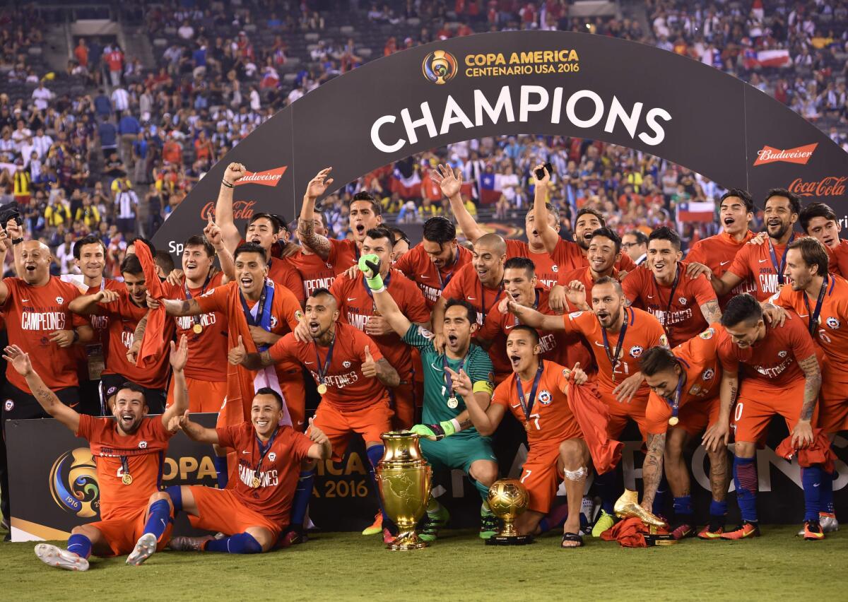 Chile's players pose with the trophy after winning the Copa America final by defeating Argentina in the penalty shootout.