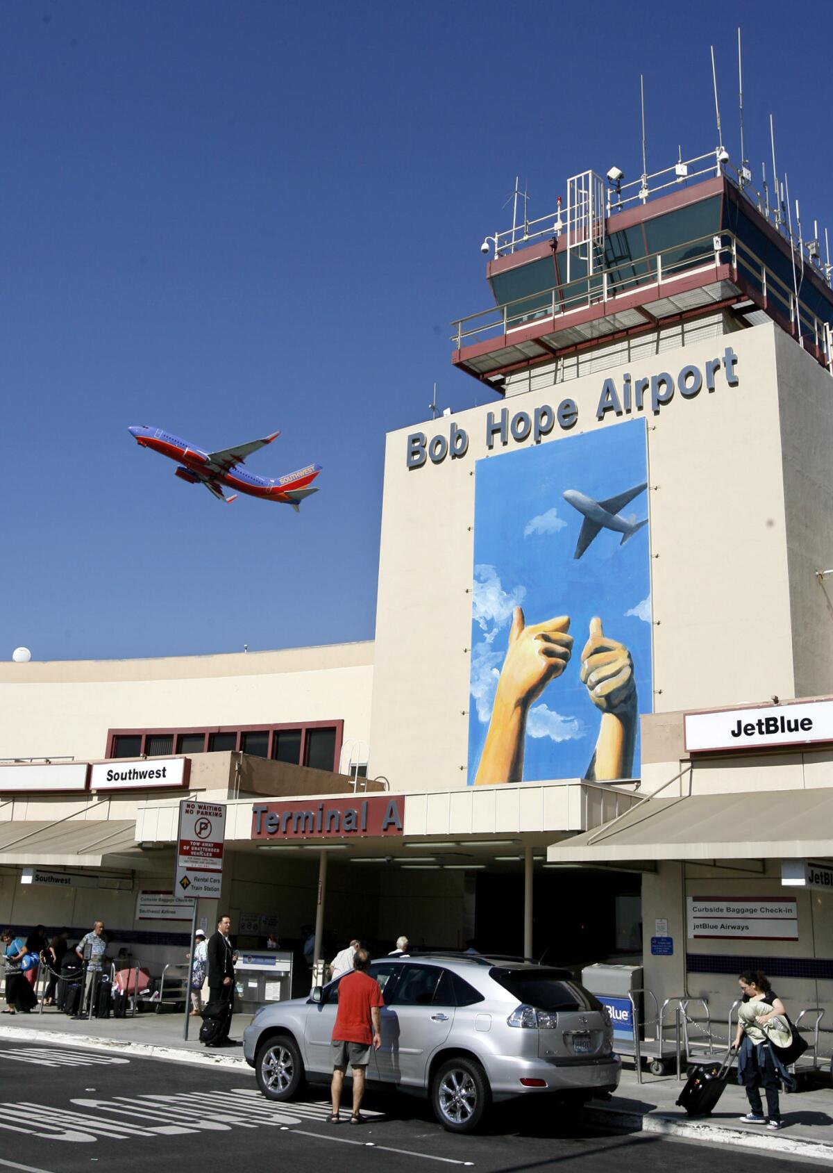 An airplane takes off from Bob Hope Airport, where new art created by a student is being displayed at the airport's main entryway, on Tuesday, October 2, 2012.