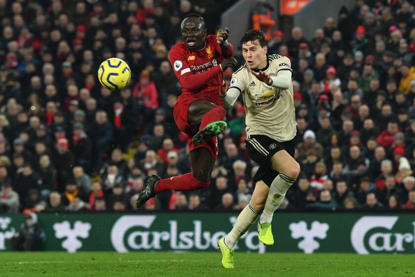 Liverpool striker Sadio Mane, left, challenges Manchester United's Victor Lindelof during an English Premier League match Jan. 19.