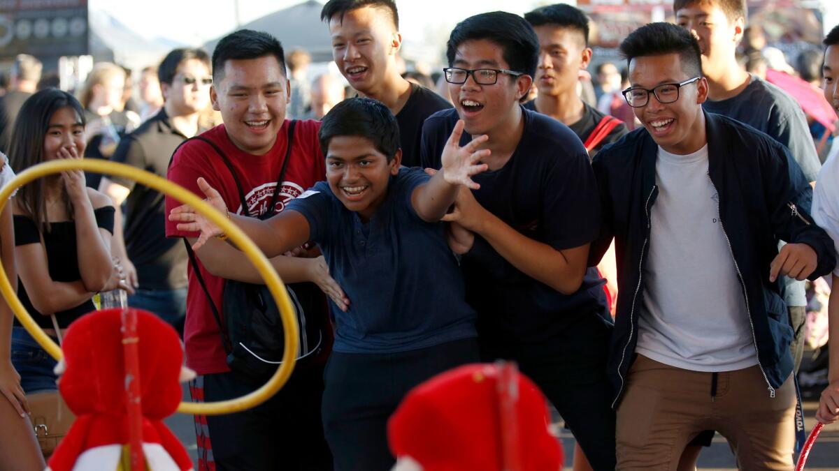 Roshan Kannan, 15, of Arcadia is surrounded by friends at the 626 Night Market this week.