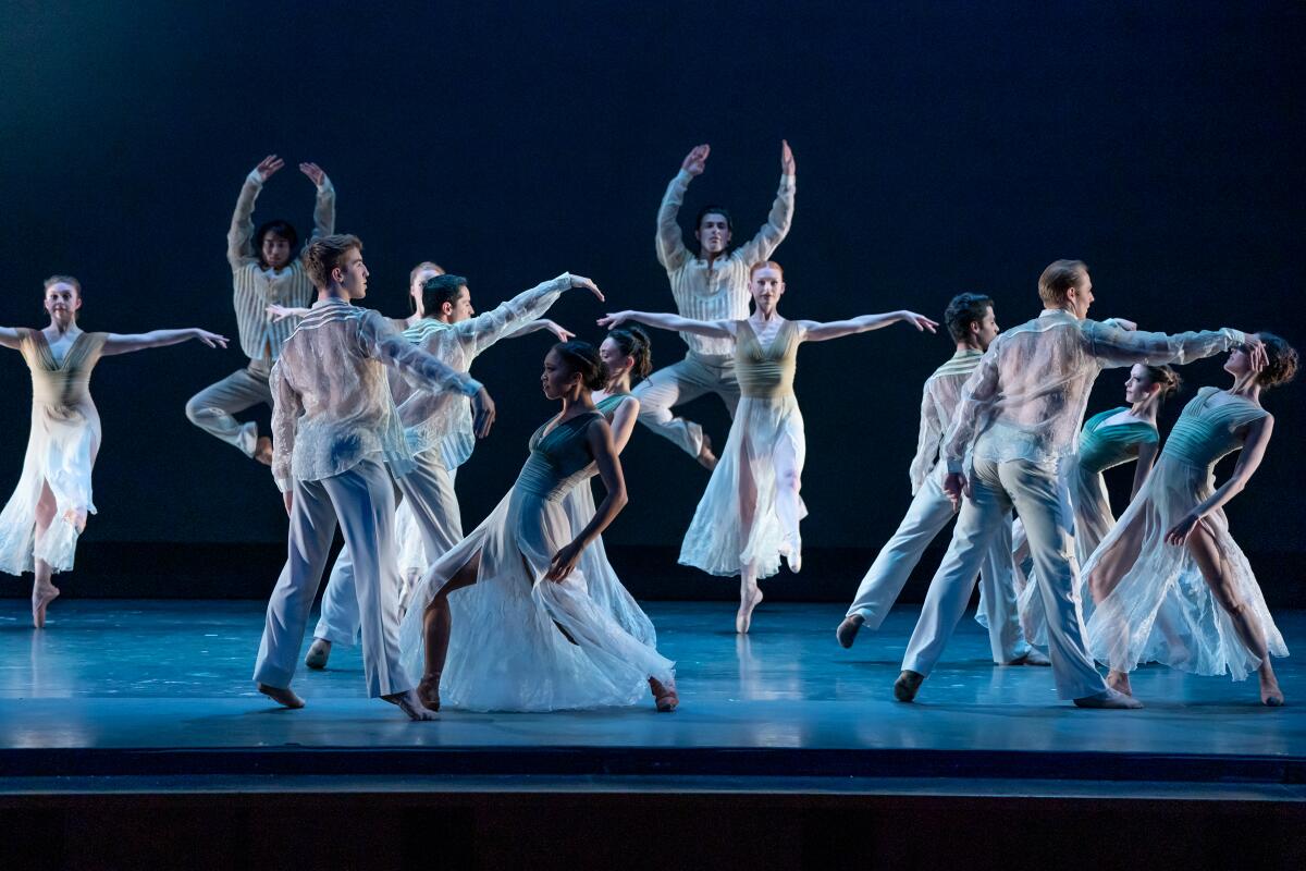 Ballet dancers perform on a stage.