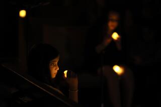 Children hold candles as Sinai Temple hosts a concert in support of Israel.