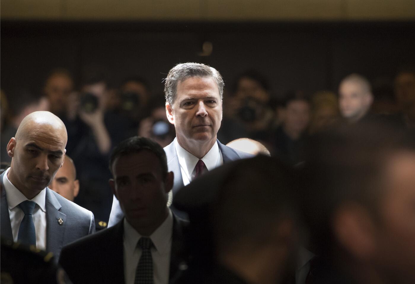 Former FBI director James Comey heads to a secure room to continue his testimony to the Senate Select Committee on Intelligence, on Capitol Hill in Washington.