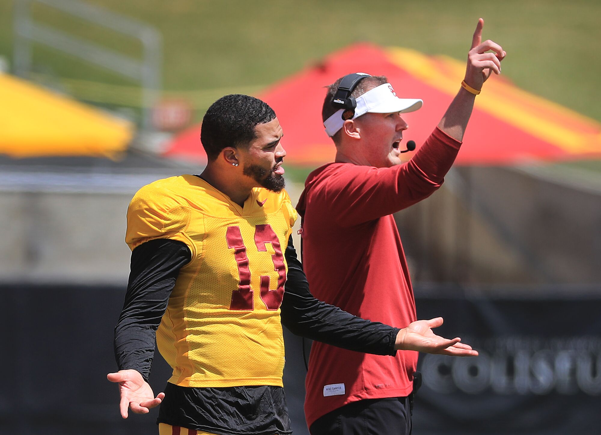 USC quarterback Caleb Williams, left, and USC head coach Lincoln Riley react to a play during the spring game in April.