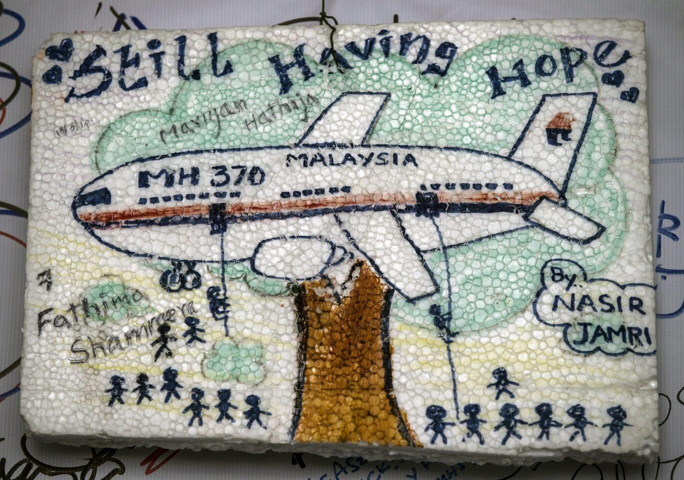 A message of support is displayed at the wall of hope for the missing passengers of the Malaysian Airlines plane at Kuala Lumpur International Airport viewing gallery, Malaysia, 18 March 2014.