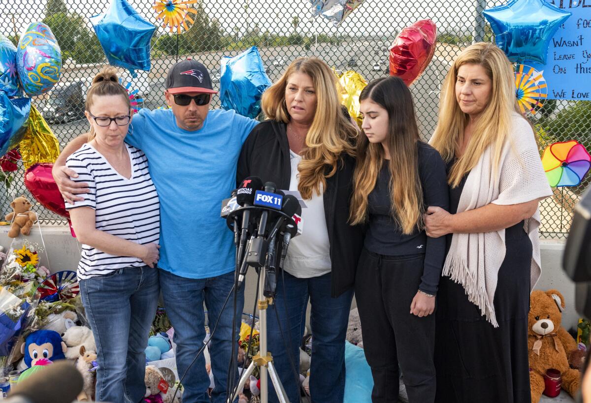 Family members of 6-year-old Aiden Leos stand at a makeshift memorial on the Walnut Avenue overpass at the 55 Freeway in Orange, Calif., Tuesday, May 25, 2021, to announce that the reward has increased to $150,000 for information leading to the suspects in the road-rage shooting death of Leos. Family members pictured are, from left, Cherrie Cloonan, John Cloonan, Carole Ybanez, Alexis Cloonan and Carly Lacy. (Leonard Ortiz/The Orange County Register via AP)