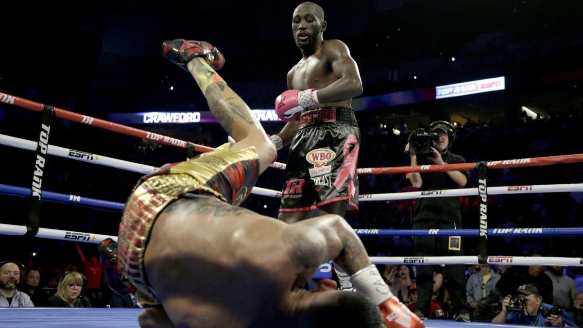 Terence Crawford watches as Jose Benavidez goes down in the 12th round.