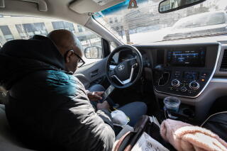 Civil rights attorney James Cook steps into his car to warm up and make phone calls in Minneapolis.