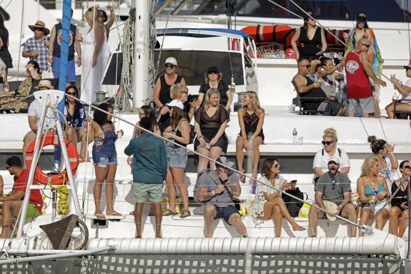 At the marina in Cabo San Lucas, Mexico, a group of visitors returns to the docks after a day on the water. The Grand Princess cruise ship passed through the same port in February.