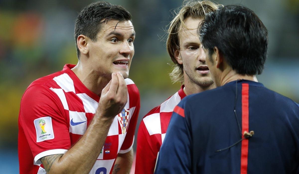 Croatia defender Dejan Lovren, left, and teammate Ivan Rakitic complain to referee Yuichi Nishimura after he called a foul on Lovren that led to a Neymar penalty shot and goal.