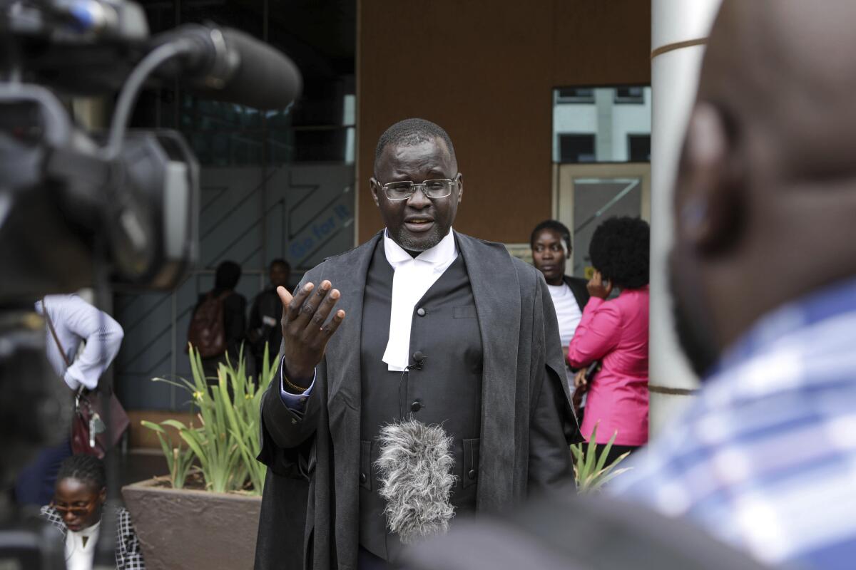 Nicholas Opiyo speaks to journalists outside the Constitutional Court in Kampala, Uganda.