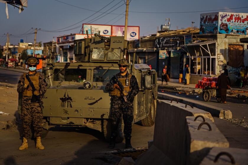 KABUL, AFGHANISTAN -- AUGUST 29, 2021: Taliban fighters widen the perimeter outside the airport as the U.S. military completes its withdrawal from the country, in Kabul, Afghanistan, Sunday, Aug. 29, 2021. (MARCUS YAM / LOS ANGELES TIMES)