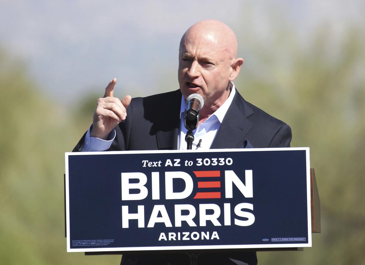 Mark Kelly speaks at a Tucson drive-in campaign rally on Oct. 28.