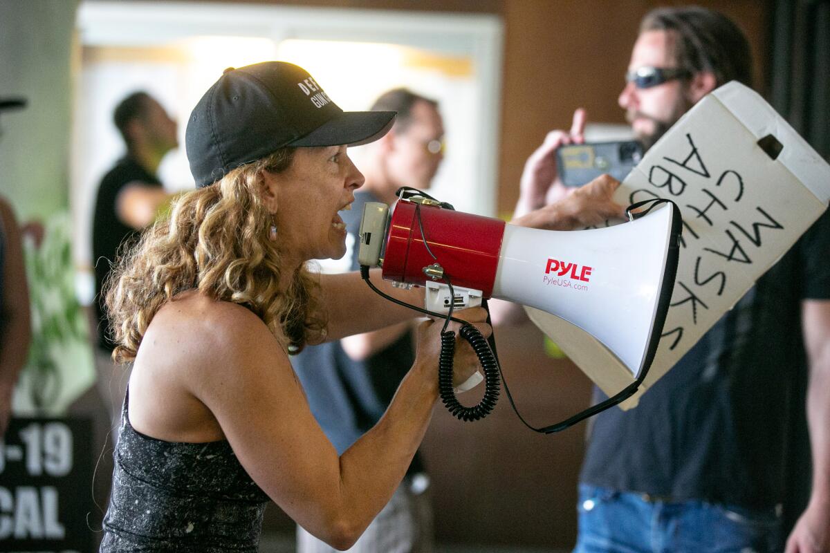 A demonstrator opposed to masking and mandatory vaccination for students outside LAUSD headquarters.