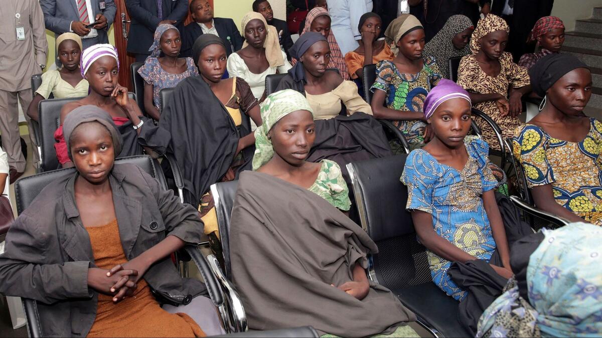 In this file photo released by the Nigeria State House, Chibok schoolgirls recently freed from Islamic extremist captivity are seen during a meeting with Nigerian Vice President Yemi Osinbajo in Abuja, Nigeria.