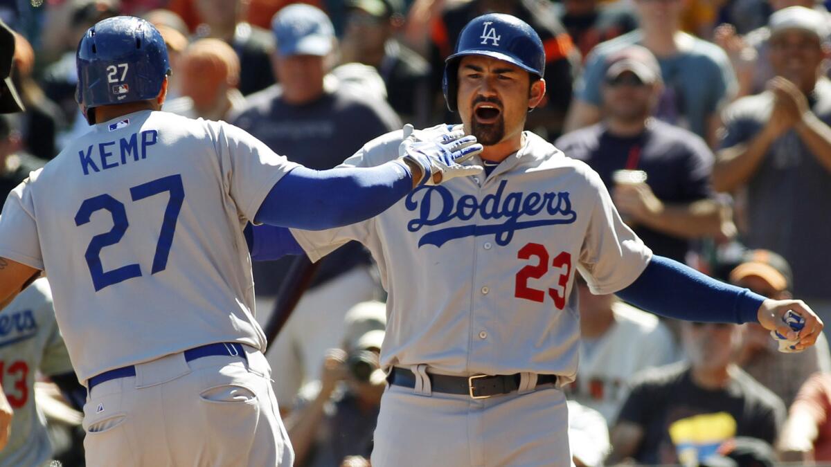 Dodgers right fielder Matt Kemp, left, is congratulated by teammate Adrian Gonzalez after hitting a home run during Sunday's win over the San Francisco Giants.