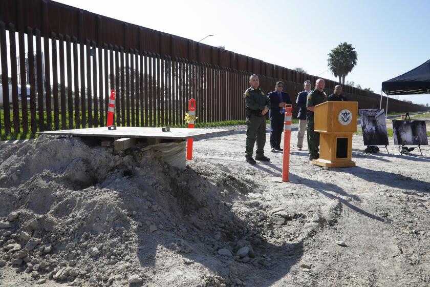 Standing next to drilled bore hole (done by officials to help map the tunnel) to a tunnel, Deputy Chief Patrol Agent Aaron Heitke (r) and Special Operations Supervisor Cesar Sotelo (l) answered questions from news reporters during a press conference held near the Otay Mesa Port of Entry about the illegal tunnel. The tunnel is reported to be constructed to smuggle drugs into the U.S. And described as the longest illicit cross-border tunnel ever discovered along the southwest border. The total length of the tunnel extends 4,309 ft, five and half feet tall, two feet wide, and about 70 feet below the ground surface. The tunnel is equipped with rail cart system, air ventilation, high voltage electrical cables and an elevator at the tunnel entrance and a drainage system. NOTE: This is not the tunnel entrance or exit.