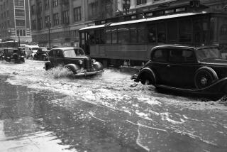 March 2, 1938: Drains could not keep up with rain filling streets in downtown Los Angeles. This photo was published in the March 3, 1938 Los Angeles Times.