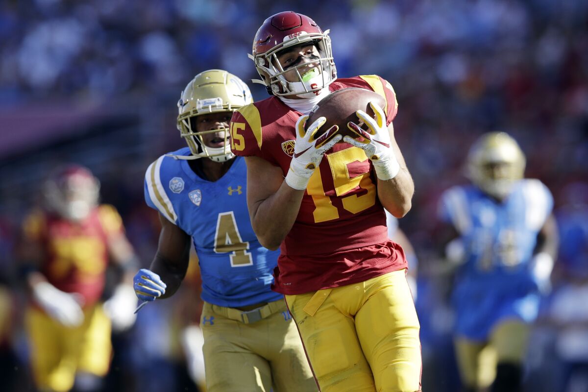FILE - In this Nov. 23, 2019, file photo, Southern California wide receiver Drake London (15) makes a catch against UCLA during the first half of an NCAA college football game in Los Angeles. Focusing on one sport for the first time, expectations are even higher for what London can accomplish on the football field, starting when No. 15 USC hosts San José State on Saturday.(AP Photo/Marcio Jose Sanchez, File)