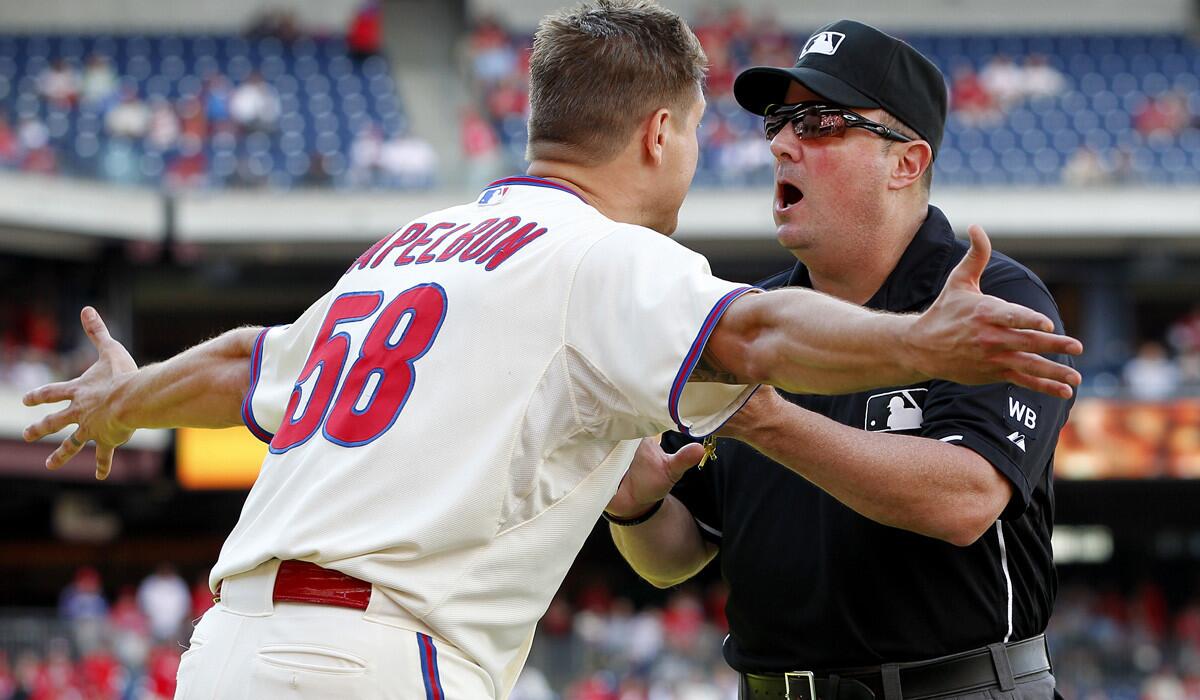 Phillies relief pitcher Jonathan Papelbon argues with umpire Marty Foster after getting ejected for making an obscene gesture after getting the final out against the Marlins in the ninth inning Sunday at Citizens Bank Park. Miami won the game, 5-4.