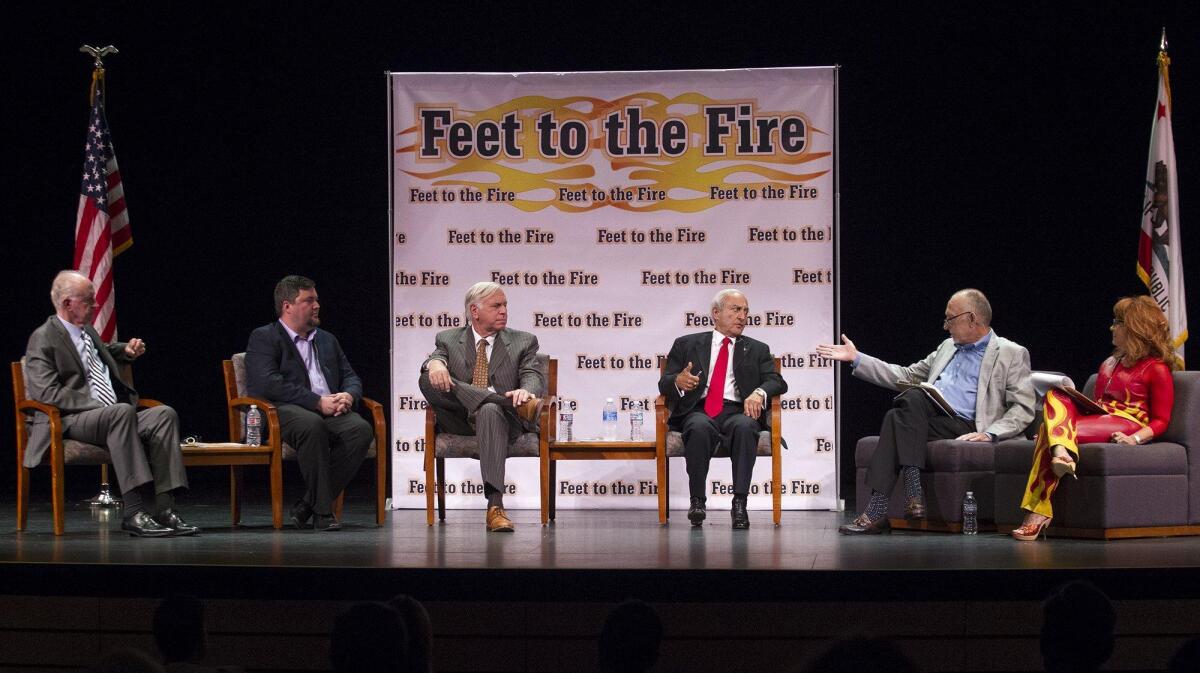 Newport Beach City Council candidates, from left, Jeff Herdman, Mike Glenn, Phil Greer and Fred Ameri take questions from former Daily Pilot Publisher Tom Johnson and Daily Pilot columnist Barbara Venezia during a Feet to the Fire forum Wednesday night at Orange Coast College in Costa Mesa.